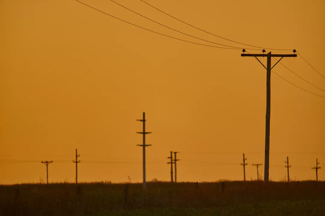 A scenery of sunset in an overhead power line