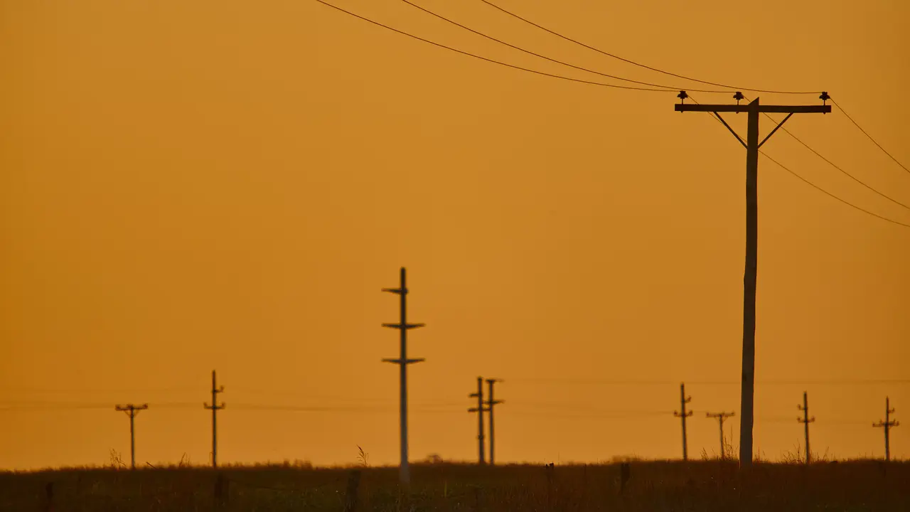 A scenery of sunset in an overhead power line